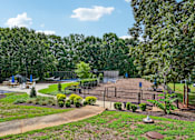 Thumbnail 95 of 107 - A playground with a swing set and a slide.