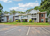 Thumbnail 56 of 107 - A row of houses with a parking lot in front.