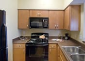 Thumbnail 11 of 18 - Fully Equipped Kitchen at The Ambassador at Library Square, Indianapolis, IN