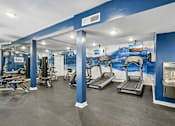 Thumbnail 88 of 107 - A gym with treadmills, weights, and exercise equipment.