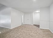 Thumbnail 75 of 107 - A room with white walls and carpeted floor.