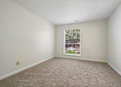 Thumbnail 64 of 107 - A room with a carpeted floor and a window.