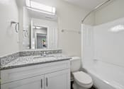 Thumbnail 60 of 107 - A bathroom with a sink, toilet, and bathtub.