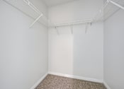 Thumbnail 61 of 107 - Empty room with white walls and carpeted floor.