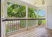 Thumbnail 67 of 107 - A screened porch with a wooden floor and white walls.