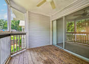 Thumbnail 70 of 107 - A sunny day on a wooden deck with a sliding glass door.