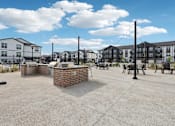 Thumbnail 46 of 53 - Outdoor grilling and seating area at Nook Nine community