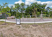 Thumbnail 43 of 53 - Outdoor playground at Nook Nine Apartments near wooded trails