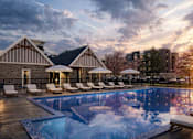 Thumbnail 2 of 8 - A large swimming pool in front of a house with sun loungers.