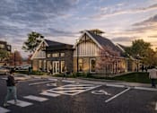 Thumbnail 1 of 8 - A modern building with a pedestrian crossing in front.