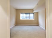 Thumbnail 17 of 18 - an empty living room with a window in it at The Ambassador at Library Square, Indianapolis, Indiana