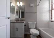 Thumbnail 31 of 35 - Updated bathroom with tile and granite countertops, lots of natural light at The Argyle on Mass Ave, Indianapolis, Indiana