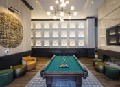 Thumbnail 17 of 53 - a pool table sits in the middle of a room with a fireplace and a chandelier
