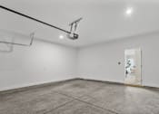 Thumbnail 18 of 37 - A white room with a door and a light on the ceiling.