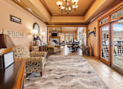 Thumbnail 14 of 36 - A welcoming lobby area with a rug, chairs, and a reception desk.