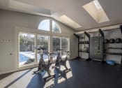 Thumbnail 9 of 33 - a gym with exercise equipment and a large window