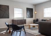 Thumbnail 13 of 33 - a living room with a couch and a table and chairs