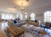 Thumbnail 6 of 33 - a living room with couches and chairs and a table