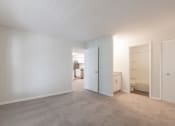 Thumbnail 22 of 33 - a bedroom with white walls and carpet