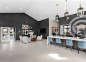Thumbnail 10 of 34 - A modern dining room with a long table and chairs.