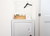 Thumbnail 25 of 34 - A white washing machine with a basket on top of it.