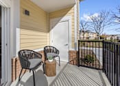 Thumbnail 23 of 34 - A patio with two chairs and a table.