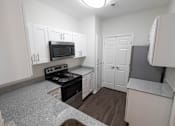 Thumbnail 6 of 34 - Renovated kitchen featuring appliance at Center Point Apartments, Indianapolis