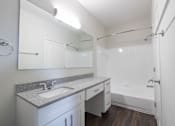 Thumbnail 8 of 34 - Renovated bathroom featuring granite counters at Center Point Apartments, Indianapolis