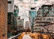 Thumbnail 2 of 18 - a person walking down a sidewalk in a city