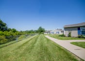 Thumbnail 15 of 18 - green space with grass in apartment community