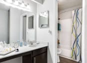 Thumbnail 8 of 10 - a bathroom with a sink and a mirror at Elea Apartments in Marietta, GA