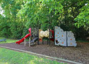 Thumbnail 2 of 10 - a playground with a slide and other toys in a park at Elea Apartments in Marietta, GA