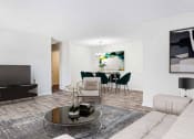 Thumbnail 6 of 10 - a living room and dining room with a couch and a table at Elea Apartments in Marietta, GA