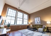 Thumbnail 9 of 22 - Living Room With Expansive Window at Harness Factory Lofts and Apartments, Indianapolis, IN