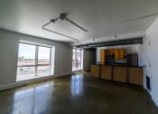 Thumbnail 11 of 23 - Living Room With Kitchen View at Janus Lofts, Managed by Buckingham Urban Living, Indianapolis