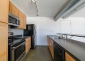 Thumbnail 14 of 23 - Remodeled Kitchen at Janus Lofts, Managed by Buckingham Urban Living, Indianapolis, IN, 46225