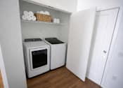 Thumbnail 8 of 22 - A white cabinet with two ovens and a basket on top.