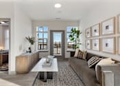 Thumbnail 6 of 27 - Bright model apartment living room at Montage featuring modern furnishings, natural light, and balcony accessw.