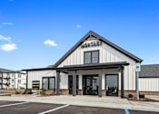 Thumbnail 27 of 27 - Leasing center exterior at Montage West Lafayette featuring modern farmhouse architecture, branded signage, and convenient parking.