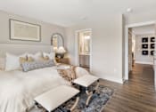 Thumbnail 23 of 45 - Elegant apartment living room at Mural Lewis Center featuring neutral tones, cozy seating, accent chairs, wood-style flooring, modern decor, and bright natural light