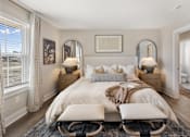 Thumbnail 19 of 45 - Primary bedroom at Mural Brownsburg rental home featuring neutral color palette, plush carpeting, and modern staging with bedside lighting