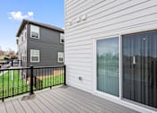 Thumbnail 43 of 45 - Rear view of rental home featuring elevated deck and sliding glass doors at Mural Lewis Center in Lewis Center, Ohio