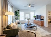 Thumbnail 11 of 53 - Living room with TV console and view into bedroom at Nook Nine apartments
