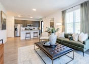 Thumbnail 9 of 53 - Apartment living room with stylish furniture and view of open kitchen at Nook Nine