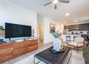 Thumbnail 10 of 53 - TV setup with wood console and open view to kitchen and bar seating at Nook Nine