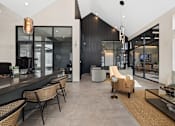 Thumbnail 9 of 20 - Modern leasing lounge at Nook Nine with high ceilings, stylish seating, and contemporary design.