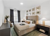 Thumbnail 7 of 20 - Elegant bedroom at Nook Nine with plush bedding, modern decor, and natural light.