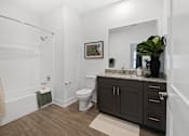 Thumbnail 4 of 20 - A bathroom with a toilet, a sink, and a shower.