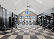 Thumbnail 19 of 20 - Bright fitness center at Nook Nine with cardio, strength training, and high ceilings for an open feel.