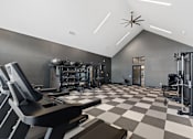 Thumbnail 17 of 20 - Spacious fitness center at Nook Nine with cardio machines, weight training, and modern design.